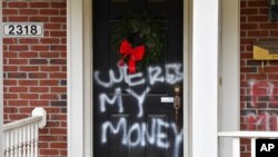 Graffiti is seen on a door of the home of Senate Majority Leader Mitch McConnell, R-Ky., in Louisville, Ky., on Jan. 2, 2021.