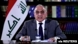 FILE - A still image taken from a video shows then-Iraqi Prime Minister Adel Abdul-Mahdi delivering a speech on reforms ahead of planned protest, in Baghdad, Oct. 25, 2019. 