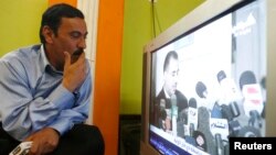 An man watches television in Baghdad, Iraq (file photo).