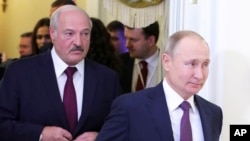 FILE - Belarusian President Alexander Lukashenko, left, and Russian President Vladimir Putin walk before a meeting in St. Petersburg, Russia, Dec. 20, 2019.