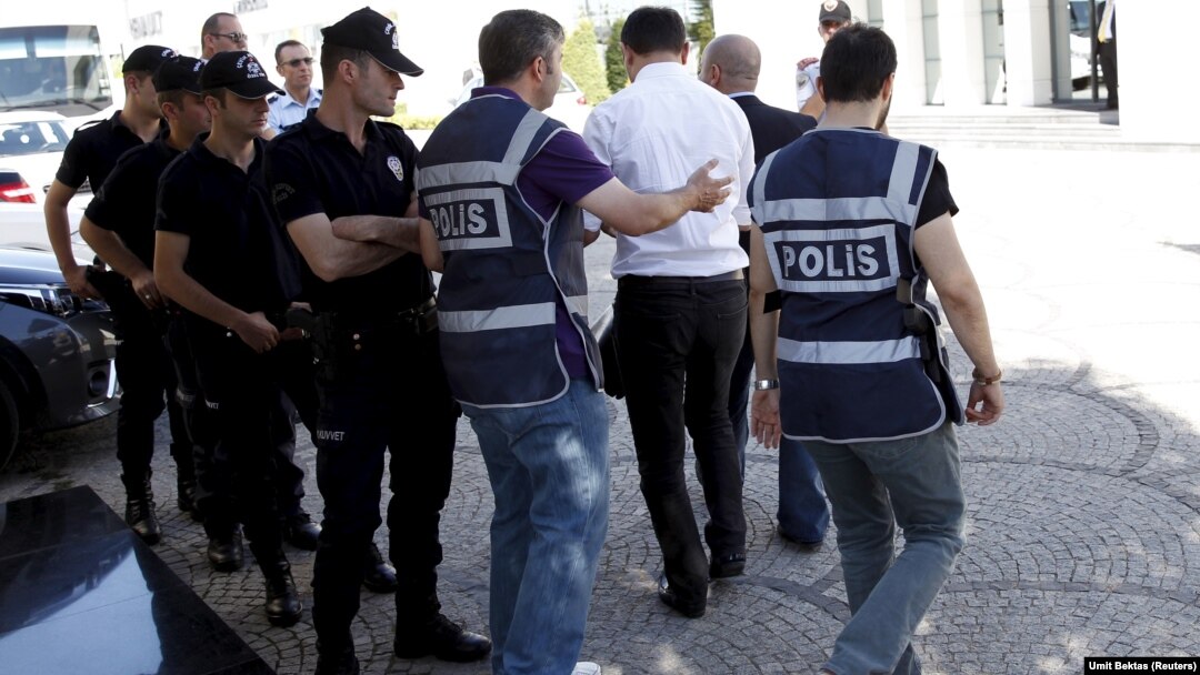 Police officers frisk an employee of the Koza Ipek Group during a raid at the company's office in Ankara, Turkey, September 1, 2015. Turkish police raided the offices of the conglomerate with close links to U.S.-based Muslim cleric Fethullah Gulen, an all
