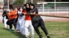 Women pull a rope during a sports event in connection with the International Women's Day celebrations in Peshawar, Pakistan March 8, 2021.