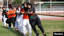 Women pull a rope during a sports event in connection with the International Women's Day celebrations in Peshawar, Pakistan March 8, 2021.