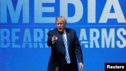 FILE - U.S. President Donald Trump gestures after speaking at a National Rifle Association convention in Dallas, Texas, May 4, 2018. 