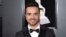 FILE - Luis Fonsi arrives at the 60th annual Grammy Awards in New York, Jan. 28, 2018. 