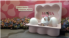 A young South Korean woman poses for a picture in front of a display at a pop-up store run by Maria Hospital, a Seoul fertility clinic that is encouraging women to freeze their eggs to preserve fertility, Aug. 23, 2024.