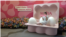 A young South Korean woman poses for a picture in front of a display at a pop-up store run by Maria Hospital, a Seoul fertility clinic that is encouraging women to freeze their eggs to preserve fertility, Aug. 23, 2024.