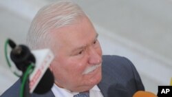 FILE - Former Polish President Lech Walesa speaks to journalists, in Warsaw, Poland, Aug. 6, 2015. Walesa denies he informed on people to the communist regime or took money from the secret security services.