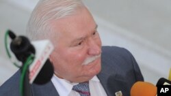 FILE - Former Polish President Lech Walesa speaks to journalists, in Warsaw, Poland, Aug. 6, 2015. Allegations that former president Lech Walesa was a communist-era secret informer have resurfaced after prosecutors seized documents illegally held by a former official's family.