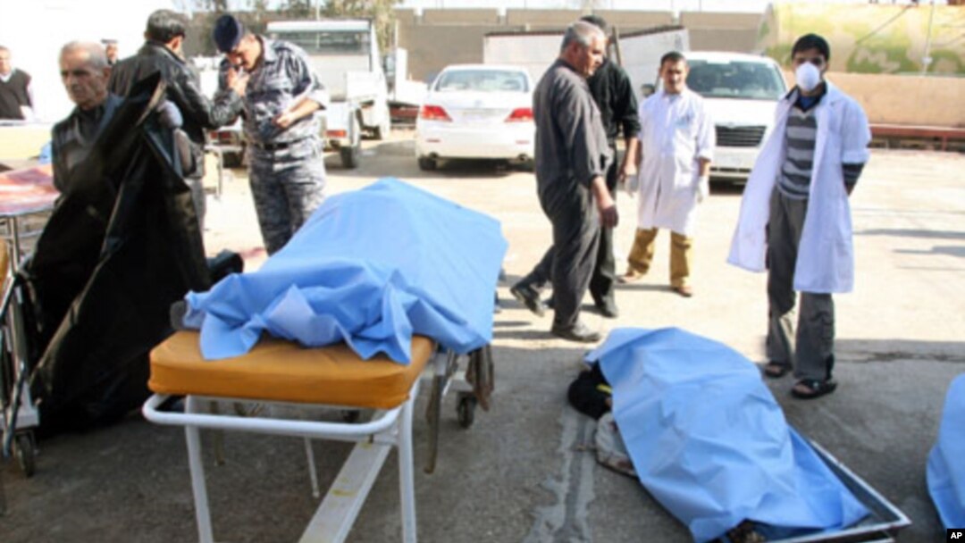 Bodies of bomb attack victims are seen outside a hospital in Tikrit, some 150 km (95 miles) north of Baghdad, 18 Jan 2011