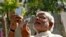 FILE - Hindu nationalist Narendra Modi, the prime ministerial candidate for India's main opposition Bharatiya Janata Party (BJP), takes a "selfie" with a mobile phone after casting his vote at a polling station during the seventh phase of India's general 