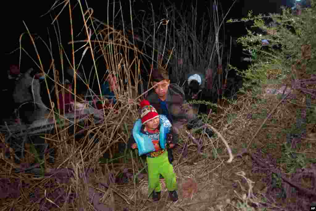 A child weeps as he is unloaded from an inflatable raft after being smuggled into the United States by crossing the Rio Grande River in Roma, Texas, March 28, 2021.