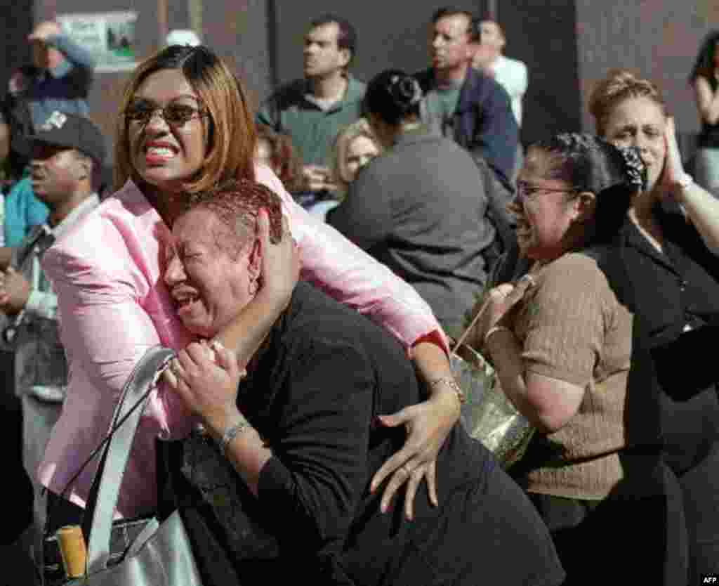 Two women hold each other as they watch the World Trade Center burn following a terrorist attack on the twin skyscrapers in New York Tuesday, Sept. 11, 2001. Terrorists crashed two planes into the World Trade Center and the twin 110-story towers collapse