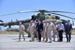 FILE - Syrian President Bashar Assad inspects the Russian Hmeimim air base in the province of Latakia, Syria, June 27, 2017. (Official Facebook page of the Syrian Presidency)