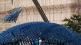 A segment to be assembled onto a sculpture containing 7,000 recycled plastic water bottles with LED lights, measuring 20 meters in diameter and 10 meters in height, is dangled from a crane at Hong Kong&#39;s Victoria Park. The &quot;Rising Moon&quot; is a giant lantern created to celebrate the upcoming Mid-Autumn Festival which falls on Sept.19.