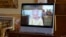 Queen Elizabeth II appears on a screen via videolink from Windsor Castle, where she is in residence, during a virtual audience at Buckingham Palace, London, Oct. 26, 2021. 