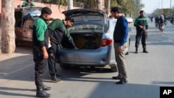 FILE - Police officers check a vehicle in Faisalabad, Jan. 15, 2019. Pakistan counterterrorism police have arrested an al-Qaida leader and close aide to Osama bin Laden after a yearslong manhunt, officials said July 19, 2024.