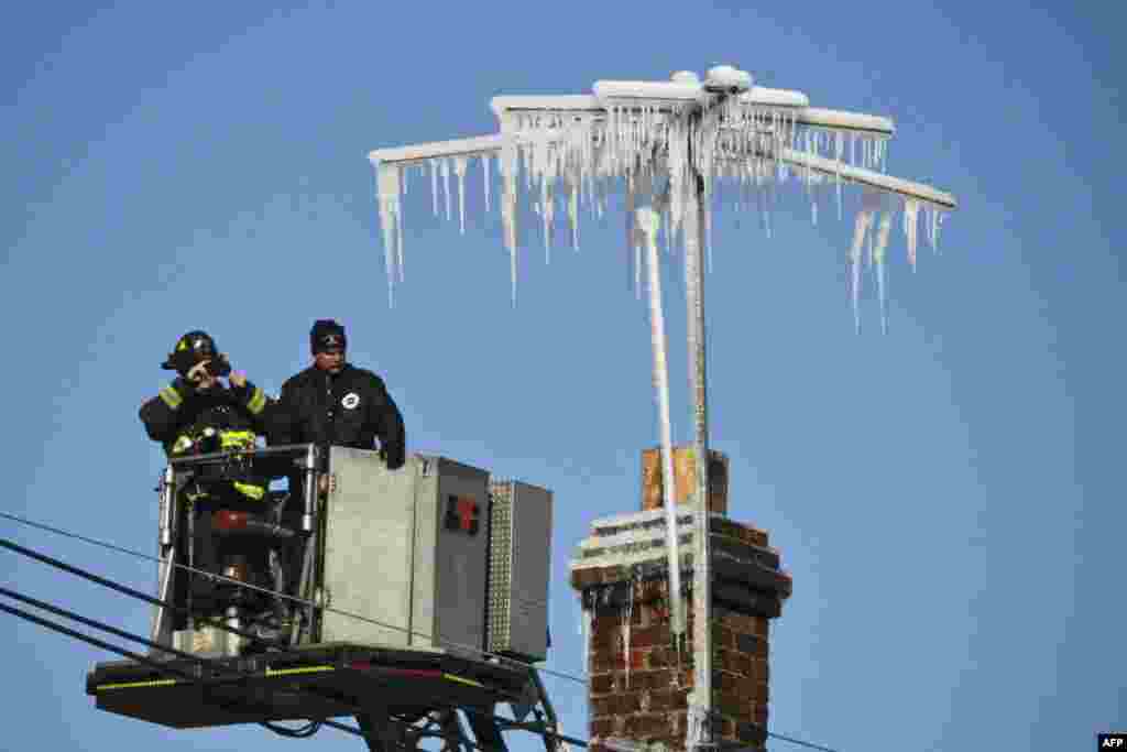 Antennae are covered in ice after firefighters battled a five alarm fire on South Broad Street near Summer Street in Elizabeth, New Jersey, USA. The fire destroyed six businesses. No serious injuries were reported.