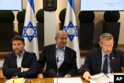 FILE - Israeli Prime Minister Benjamin Netanyahu, centre, convenes the weekly cabinet meeting at the Defence Ministry in Tel Aviv, Israel, January 7, 2024