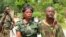 FILE - In this photo taken on Thursday, Jan. 2, 2014, a Congolese soldier, center, is helped after she and others were injured in attacks that led to the death of Congolese Col. Mamadou Ndala, near Beni, Democratic Republic of Congo. 