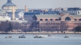 Search and rescue teams work in the aftermath of the collision of American Eagle flight 5342 and a Black Hawk helicopter that crashed into the Potomac River, as seen from Alexandria, Virginia, Jan. 30, 2025. 