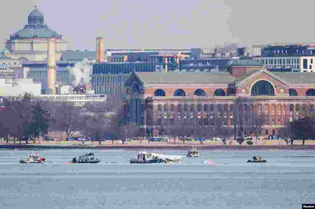 Search and rescue teams work in the aftermath of the collision of American Eagle flight 5342 and a Black Hawk helicopter that crashed into the Potomac River, as seen from Alexandria, Virginia.