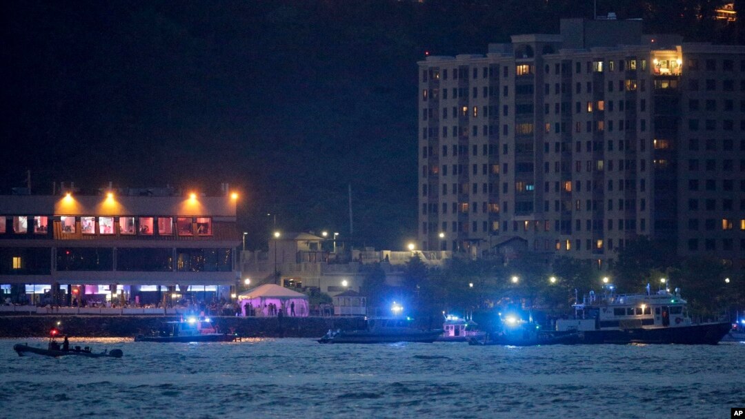 Search-and-rescue boats look for a small plane that went down in the Hudson River, May 27, 2016. 