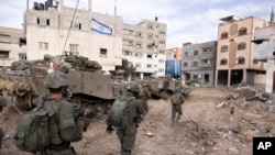 FILE - Israeli soldiers take part in a ground operation in Gaza City's Shijaiyah neighborhood, December. 8, 2023.