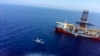 In this Tuesday, July 9, 2019 photo, a helicopter flies near Turkey's drilling ship, 'Fatih' dispatched towards the eastern Mediterranean, near Cyprus. 