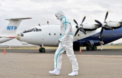 A member of a medical team wearing protective suits clean the airfield, to prevent the spread of the coronavirus disease (COVID-19), at the Juba International Airport in Juba, South Sudan April 5, 2020.