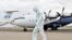 A member of a medical team wearing a protective suit cleans the airfield to prevent the spread of COVID-19 at the Juba International Airport in Juba, South Sudan, on April 5, 2020.