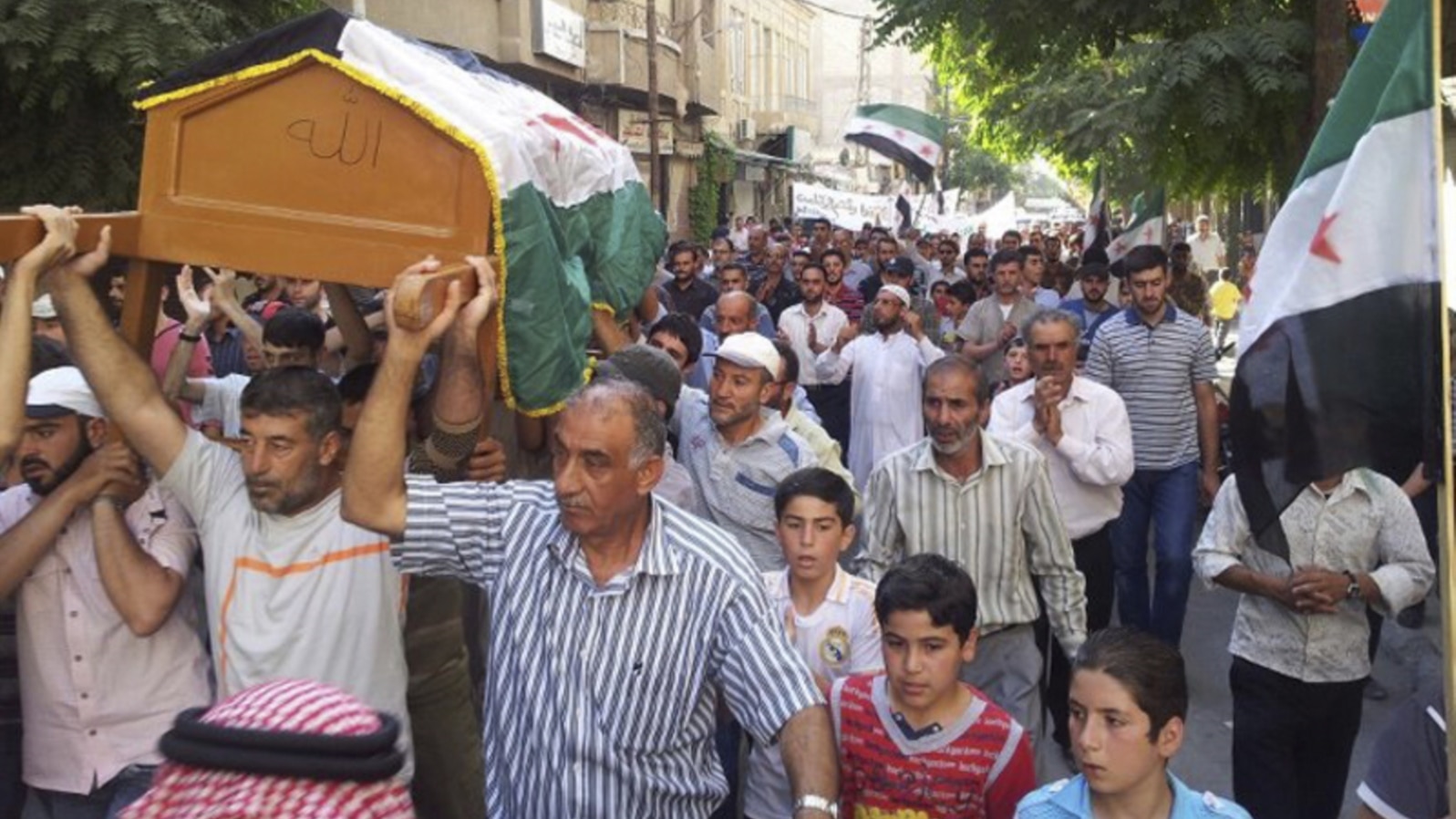 Residents carry the coffin of Muhammad Mousa, whom protesters say was killed by forces loyal to Syria's President Bashar al-Assad, during his funeral in Yabroud near Damascus July 21, 2012.