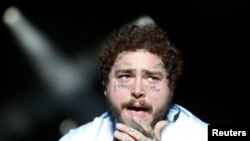 FILE - Post Malone performs during the Sziget music festival on an island in the Danube River in Budapest, Hungary, Aug. 11, 2019.