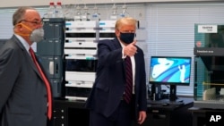 President Donald Trump gestures as he participates in a tour of Bioprocess Innovation Center at Fujifilm Diosynth Biotechnologies, Monday, July 27, 2020, in Morrisville, N.C. (AP Photo/Evan Vucci)