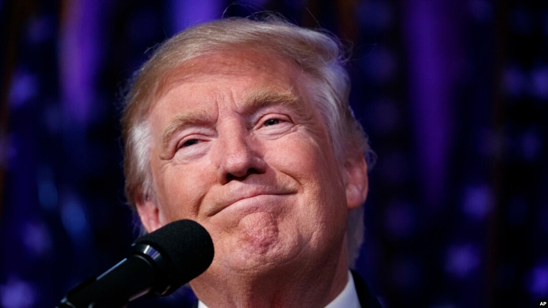 President-elect Donald Trump smiles as he arrives to speak at an election night rally, November 9, 2016. Trump, who is expected to lose the popular vote, has already won the tally that counts in the Electoral College with 290 votes. 