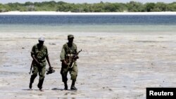 Somalia's Transitional Federal Government (TFG) soldiers patrol the Indian Ocean coastline in Burgabo, south of Kismayu in Somalia, December 14, 2011