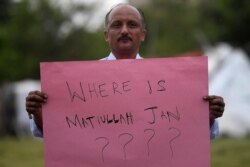 A journalist holds a placard during a protest against the seizure of Pakistani journalist Matiullah Jan in Islamabad on July 21, 2020. Jan was later released.