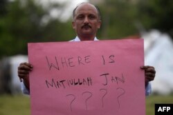 A journalist holds a placard during a protest against the seizure of Pakistani journalist Matiullah Jan in Islamabad on July 21, 2020. Jan was later released.