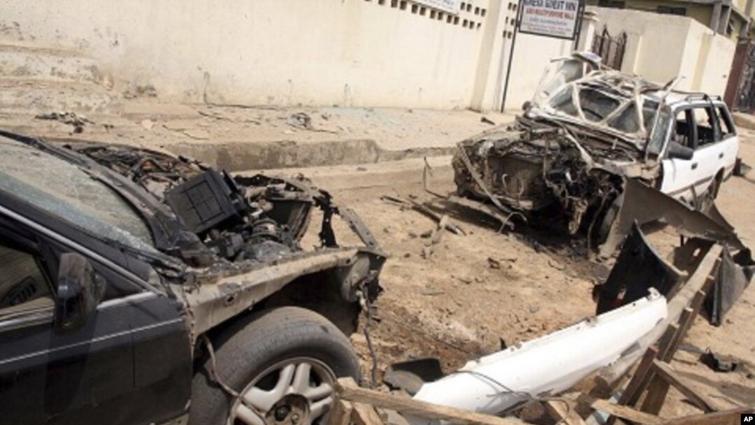 Damaged cars at the site of a bomb explosion in Suleja, Nigeria, February 19, 2012.
