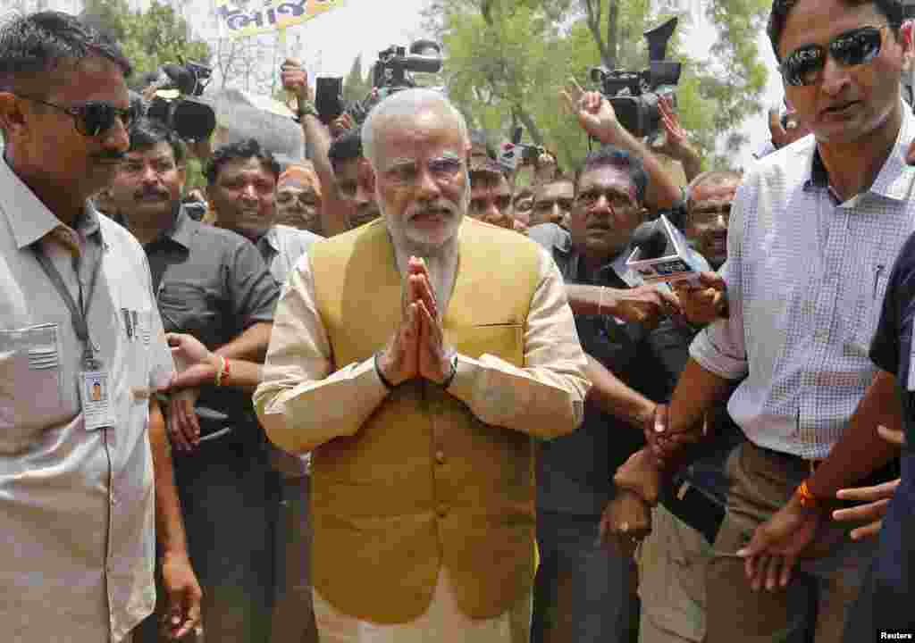 Hindu nationalist Narendra Modi (center), the presumptive prime minister of India, gestures as he arrives to seek blessings from his mother, Heeraben, at her residence in Gandhinagar, May 16, 2014.