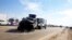 A police vehicle is towed after a suicide bomb attack in Taji, 20 km (12 miles) north of Baghdad, February 5, 2013.