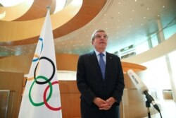 FILE - Thomas Bach, President of the International Olympic Committee (IOC), speaks in Lausanne, Switzerland, March 25, 2020.