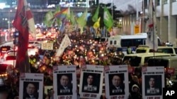 Protesters march to the presidential office after a candlelight vigil against South Korean President Yoon Suk Yeol in Seoul, South Korea, Dec. 5, 2024.