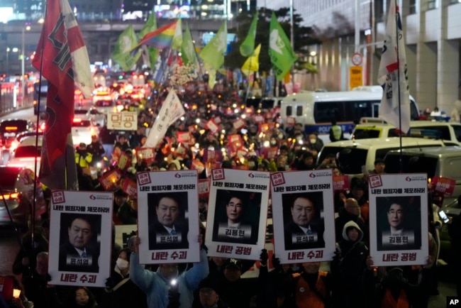 Protesters march to the presidential office after a candlelight vigil against South Korean President Yoon Suk Yeol in Seoul, South Korea, Dec. 5, 2024.