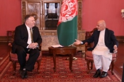 Afghanistan's President Ashraf Ghani (R) meets with U.S. Secretary of State Mike Pompeo in Kabul, Afghanistan, March 23, 2020.