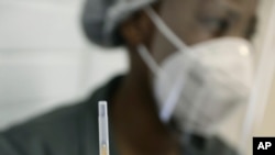 FILE - A medical staff member prepares a syringe at a hospital in Johannesburg, June 24, 2020. International crime fighting agencies are warning of the possibility of fake vaccines entering the market, especially in Africa.