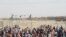 People gather and wait to welcome their relatives arriving from Afghanistan, at the Friendship Gate crossing point at the Pakistan-Afghanistan border town of Chaman, Pakistan, Aug. 17, 2021.