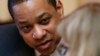 Virginia Lt. Gov. Justin Fairfax, left, listens to assistant Senate Clerk, Tara Perkinson, as he prepares to preside over the Senate at the Capitol in Richmond, Virginia, Feb. 4, 2019. 