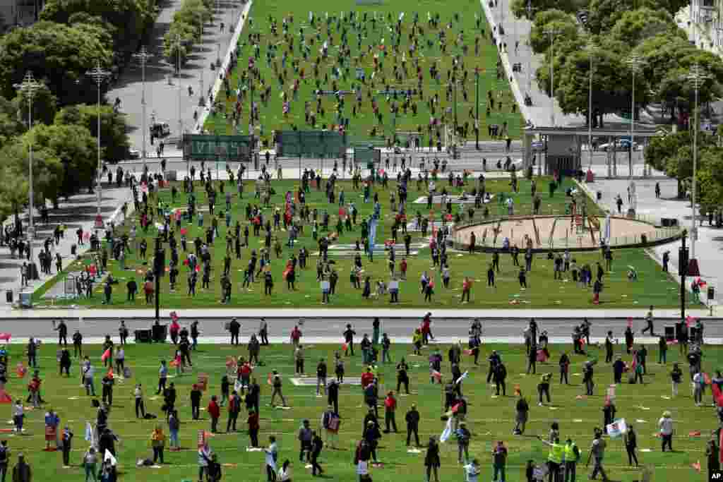 Workers unions keep a safe distance from each other and wear face masks to help protect against the spread of the new coronavirus during an event marking May Day in Lisbon, Portugal.