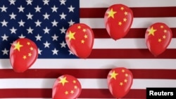 Illustration shows printed balloons with Chinese flag and U.S. flag